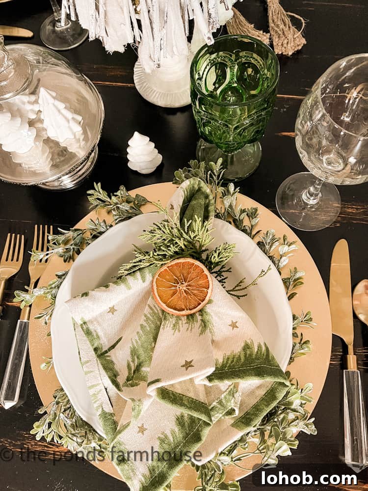 holiday table with dried oranges and greenery
