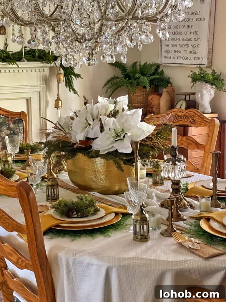 holiday table featuring gold vase with white flowers in center