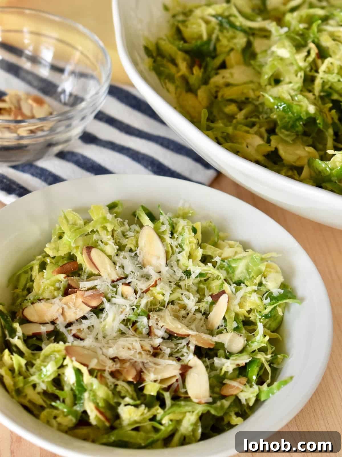 Brussels Sprouts salad with lemon vinaigrette in a white bowl.