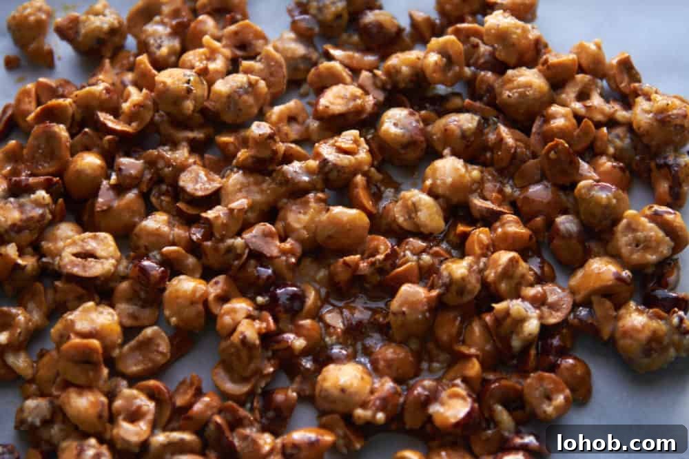 Crunchy Candied Hazelnuts Recipe for Snacks & Gifts 5 Candied hazelnuts cooling on parchment paper.