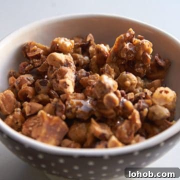 Crunchy Candied Hazelnuts Recipe for Snacks & Gifts 7 Candied hazelnuts in a brown and white polka dot bowl.