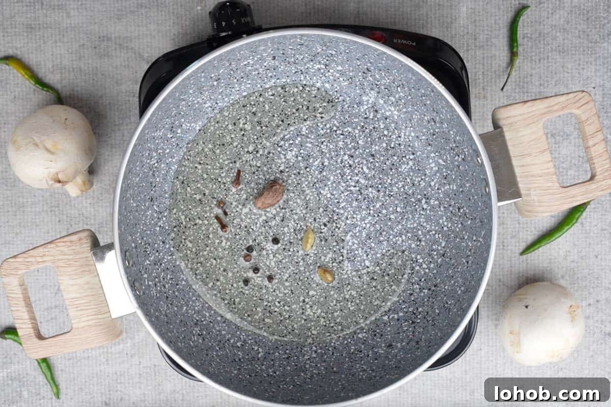Whole spices added to the pan.