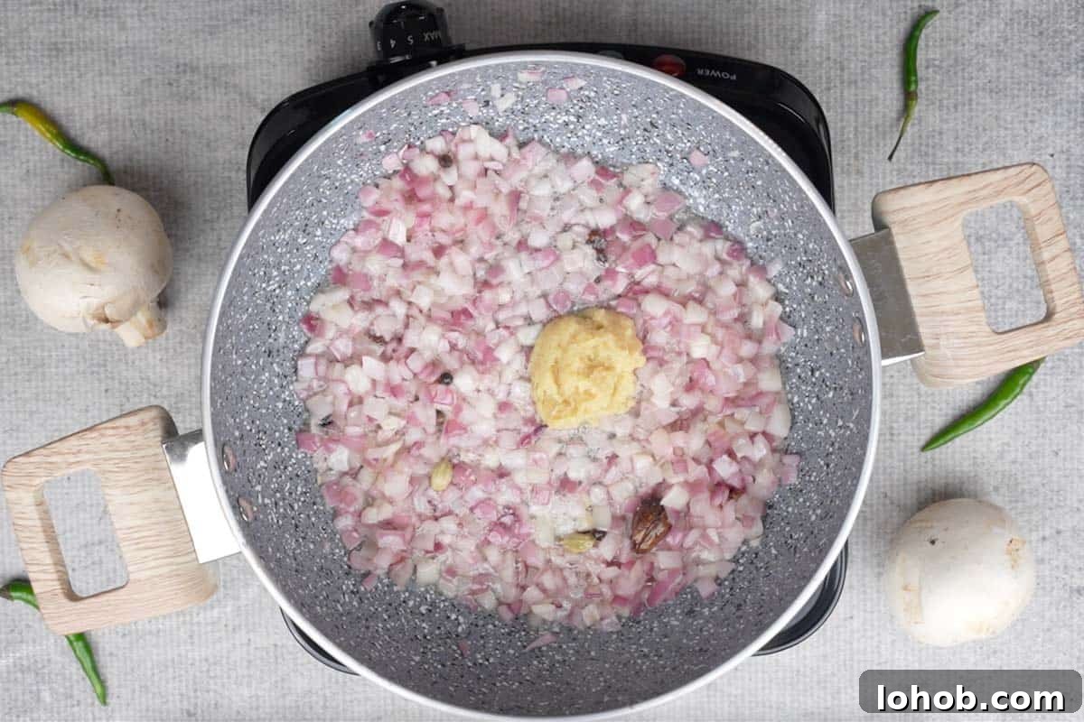 Ginger garlic paste added to the pan.