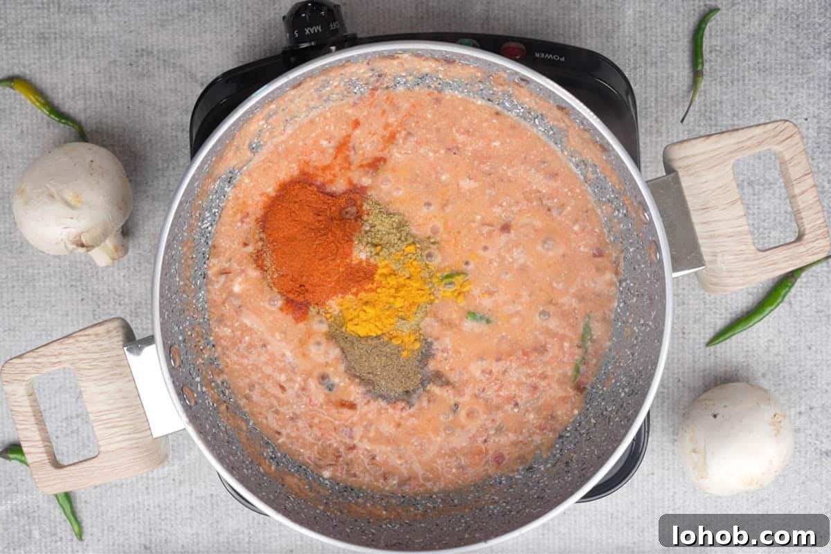 Spice powders added to the pan.