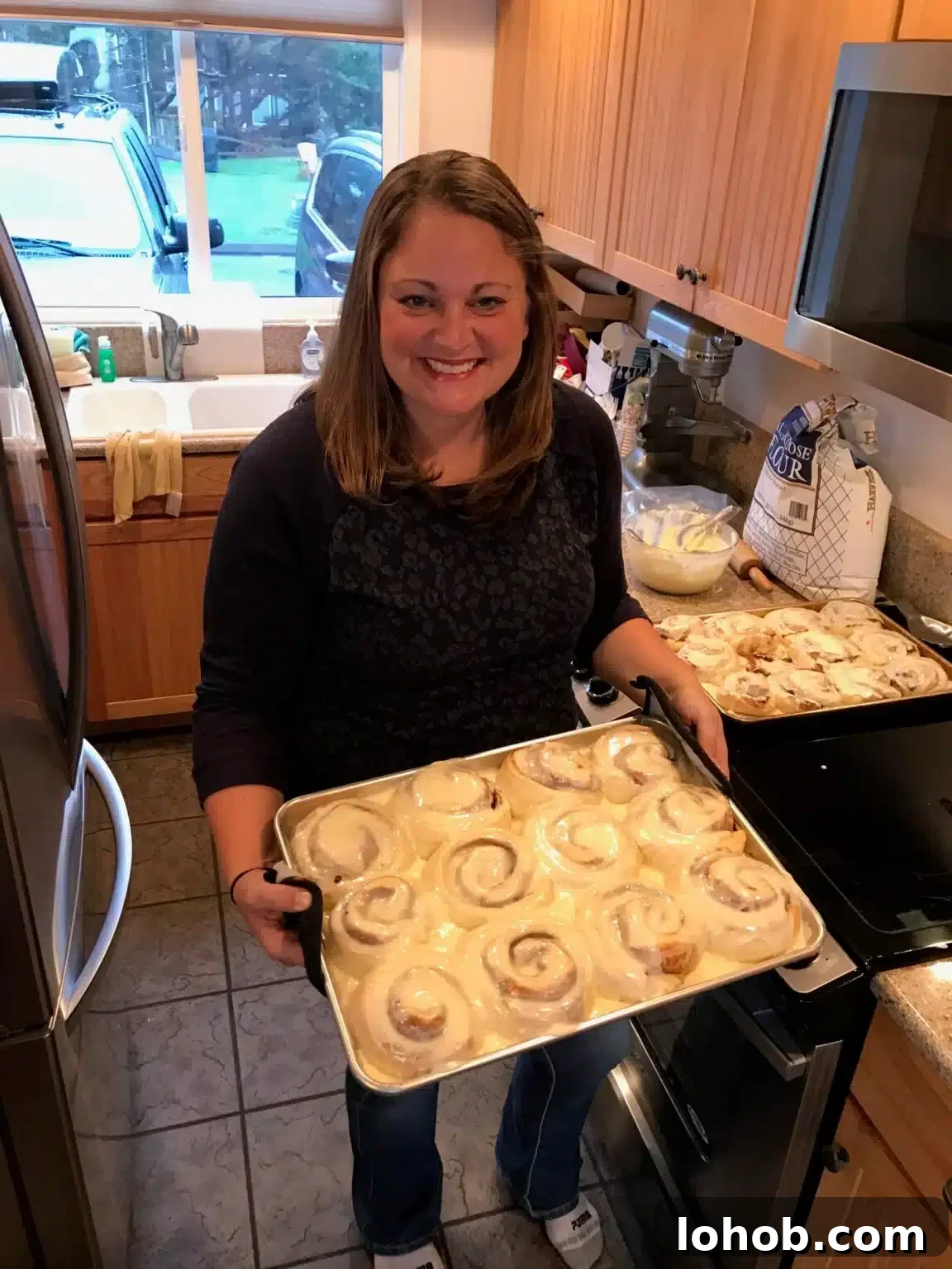 Soft Gooey Cinnamon Rolls Recipe for Perfectly Fluffy Layers 3 Amy holds a pan of cinnamon rolls.