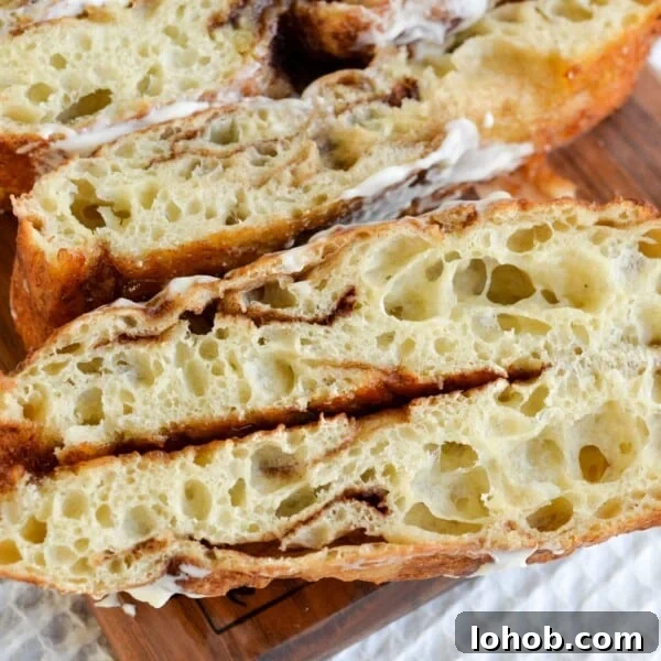 Soft Gooey Cinnamon Rolls Recipe for Perfectly Fluffy Layers 22 Sourdough cinnamon roll focaccia sliced open and placed on a board.