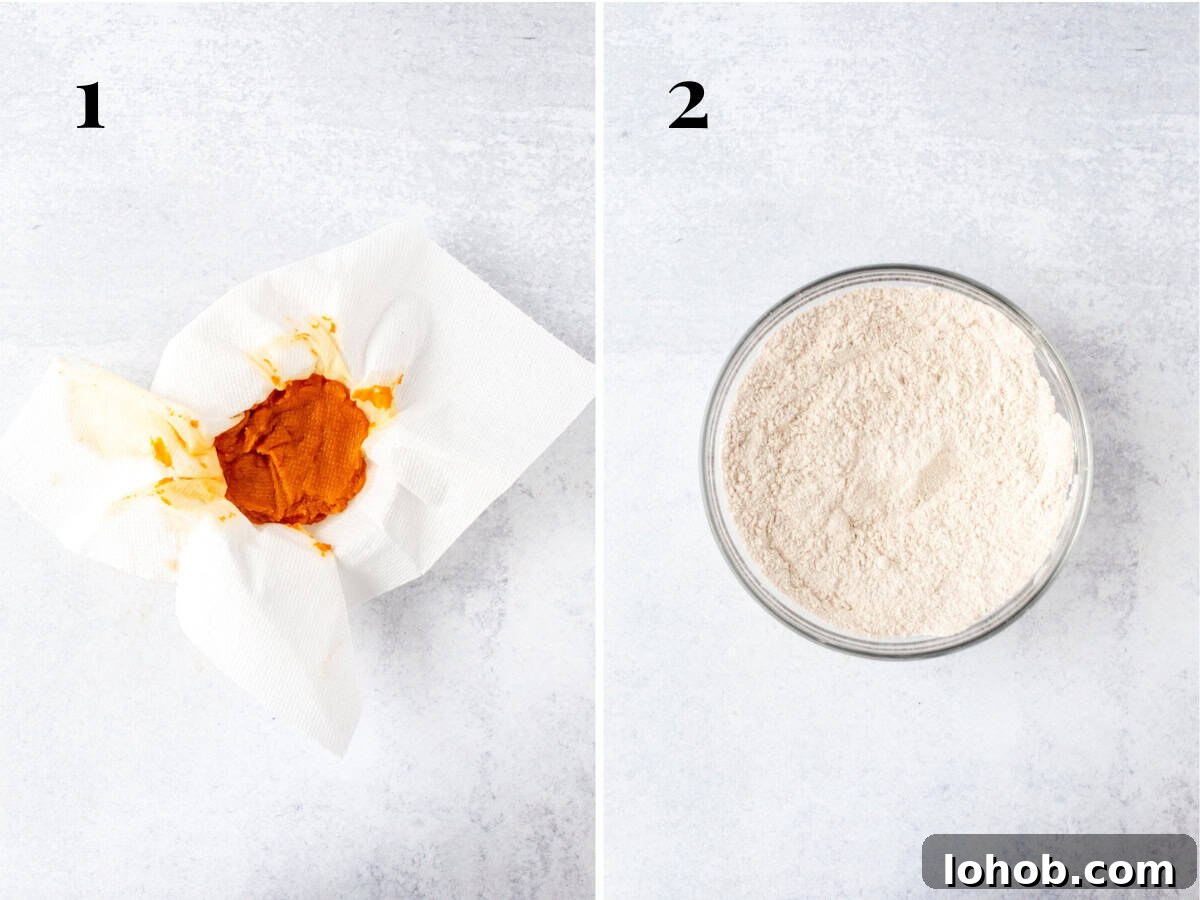 Bowl of pumpkin blotted with paper towel and bowl of dry ingredients