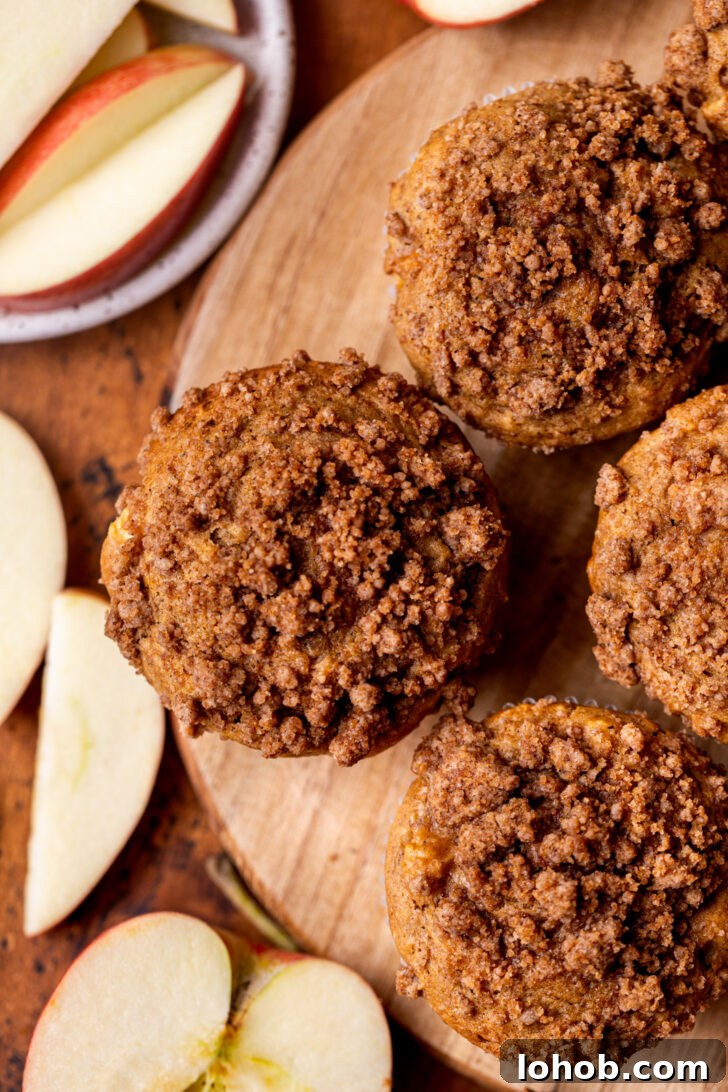 Moist Apple Muffin Recipe with Cinnamon Streusel 3 Top view of muffins on a wood board.