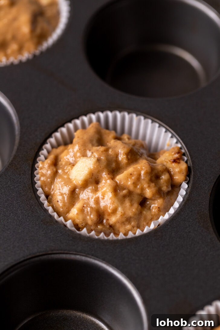 Moist Apple Muffin Recipe with Cinnamon Streusel 7 Muffin batter in the pan.