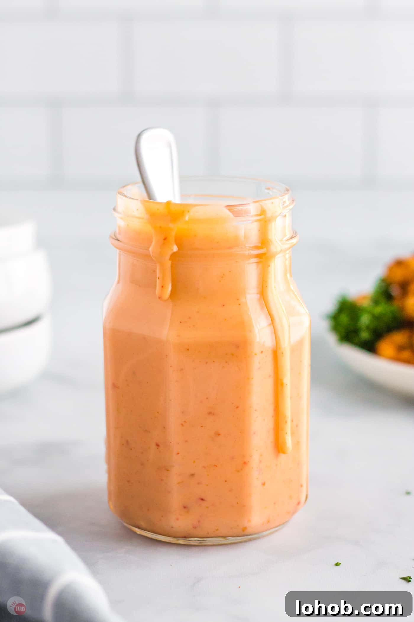 jar of sauce with spoon