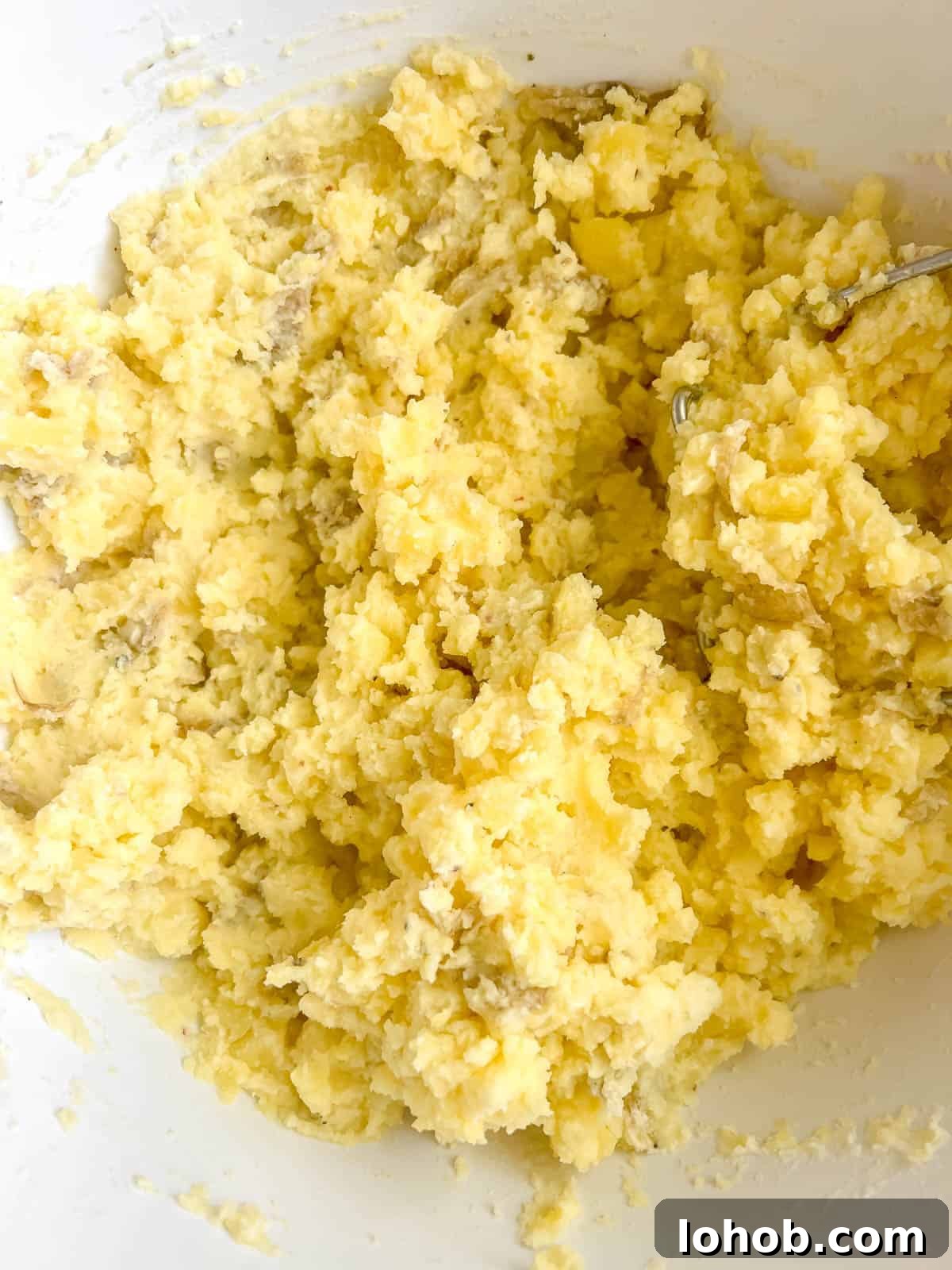 Greek yogurt in mashed potatoes in a bowl.