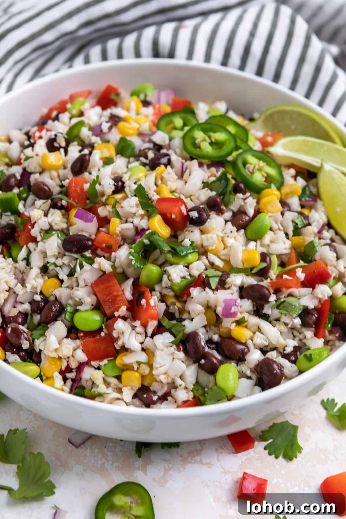 Black Bean & Cauliflower Rice Salad with Lime and Cilantro 6 White bowl with cauliflower black bean salad with jalapeño.