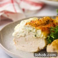 A close up of Boursin stuff chicken sliced in half to show the inside.