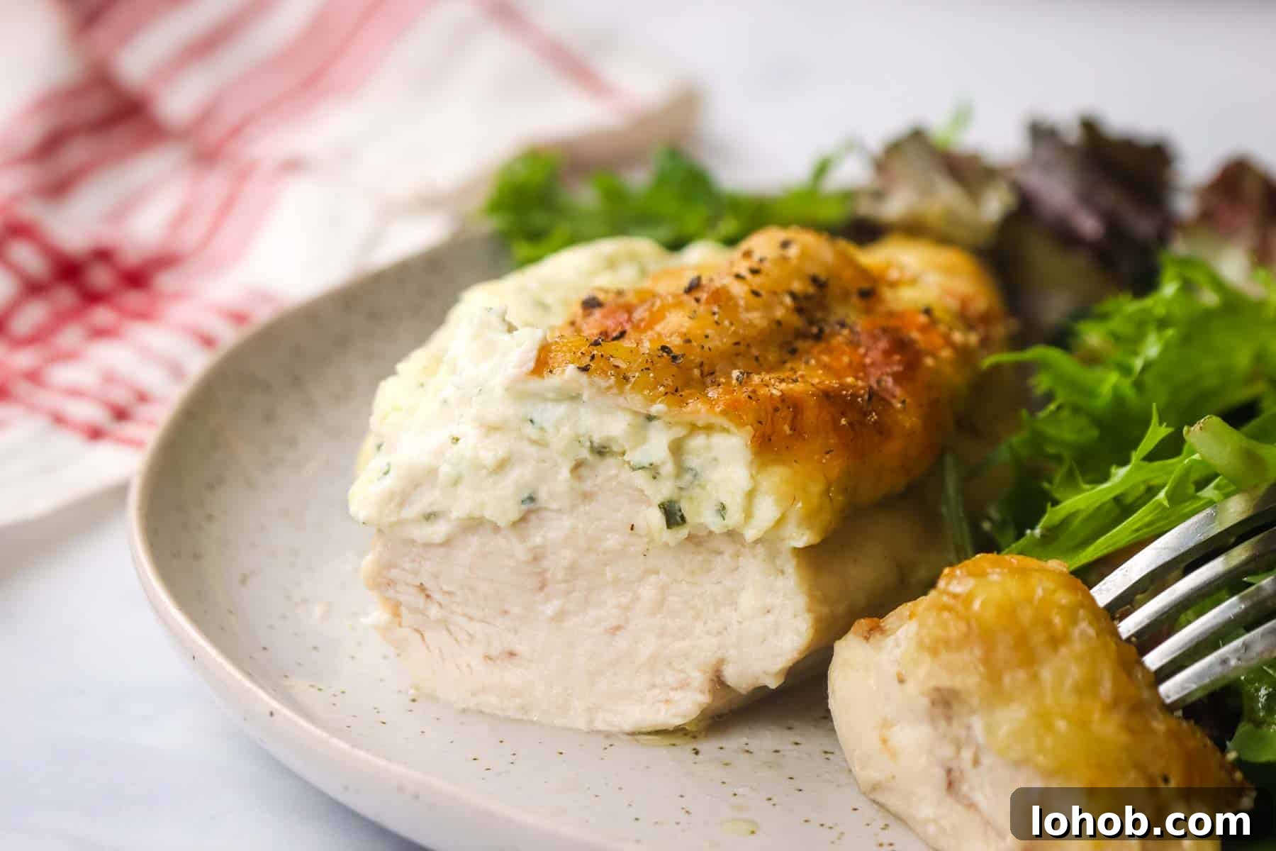 Creamy Boursin-Stuffed Chicken Breast Recipe 3 boursin chicken served in a plate with a simple side salad