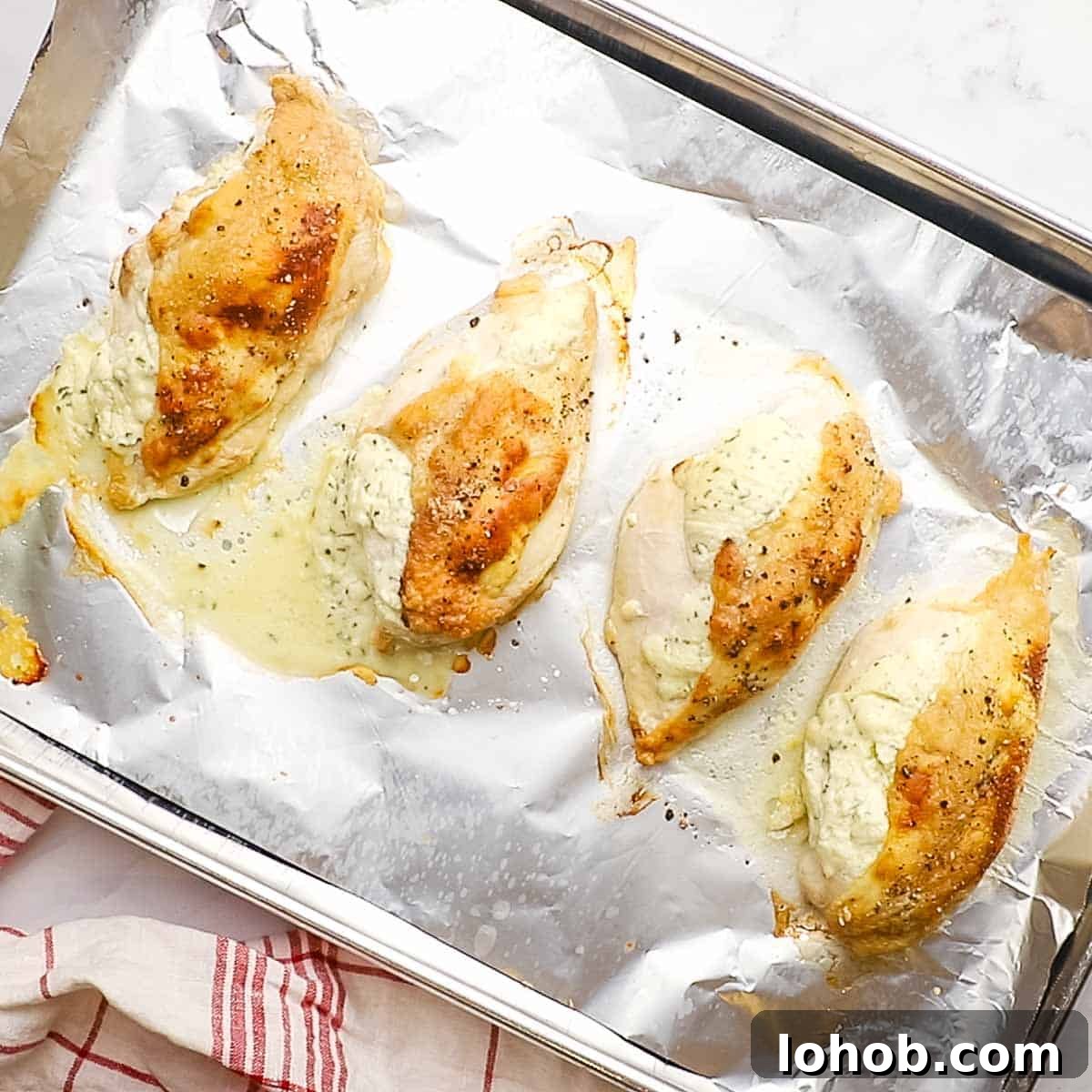 Creamy Boursin-Stuffed Chicken Breast Recipe 9 freshly roasted boursin chicken breasts on a baking sheet