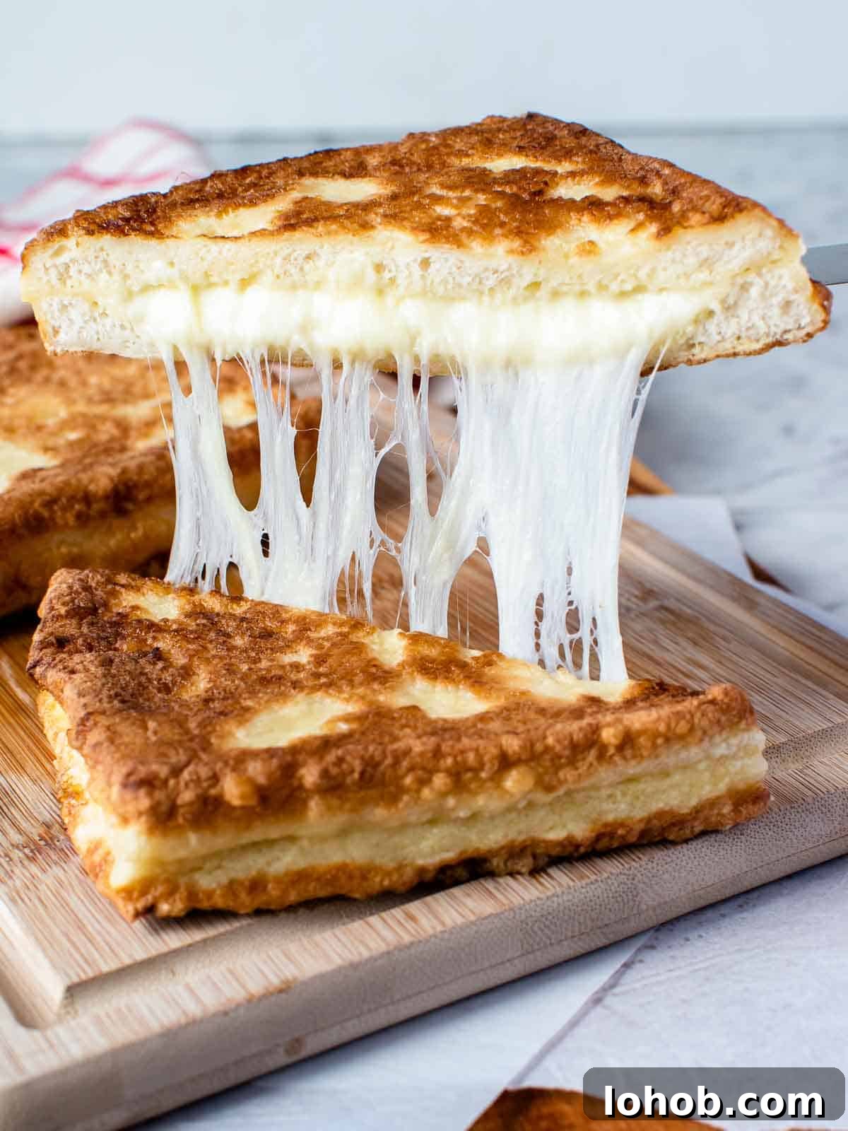 Mozzarella in Carrozza: Crispy Italian Fried Cheese Sandwich Recipe 2 Mozzarella in carrozza cut in half and showing cheese pull.
