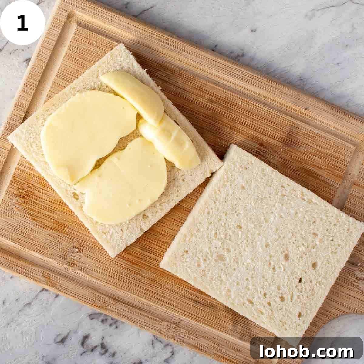 Mozzarella in Carrozza: Crispy Italian Fried Cheese Sandwich Recipe 4 Two slices of crustless white bread, one topped with mozzarella slices.