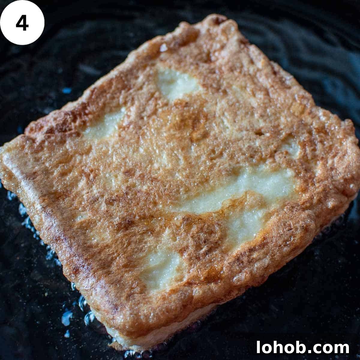 Mozzarella in Carrozza: Crispy Italian Fried Cheese Sandwich Recipe 7 Sandwich of eggy bread frying in oil in a skillet.