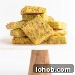 Pile of zucchini slice on a marble and wood cake stand.