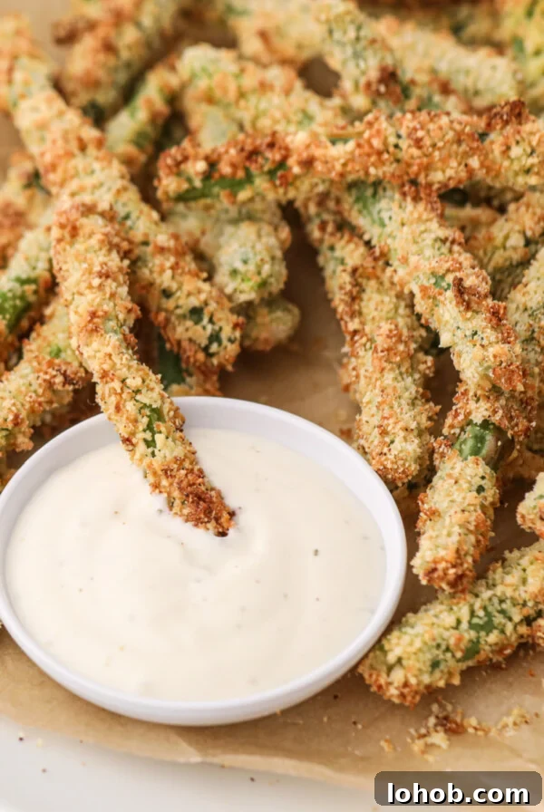 Crispy Air Fryer Green Beans with Garlic and Parmesan 9 Air Fryer Green Bean Fries with dipping sauce, ready to eat.