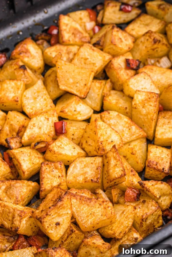 Crispy Air Fryer Green Beans with Garlic and Parmesan 8 cooked home fries in the basket of the air fryer.