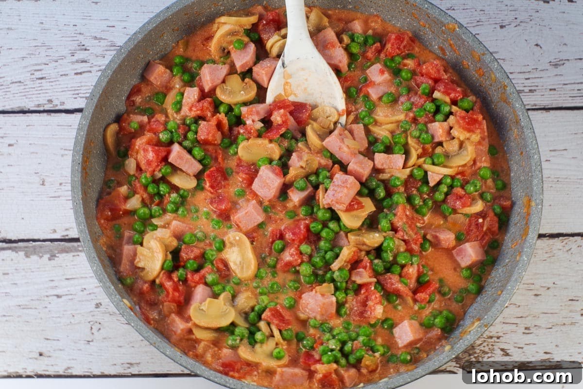 Leftover Ham and Pea Pasta Recipe for Quick Weeknight Meals 8 peas and mushrooms added to ham mixture