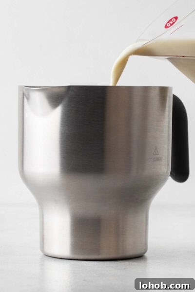 Pouring milk in an electric milk frother.