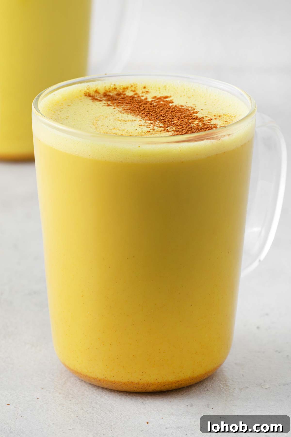 Turmeric latte in a glass mug.