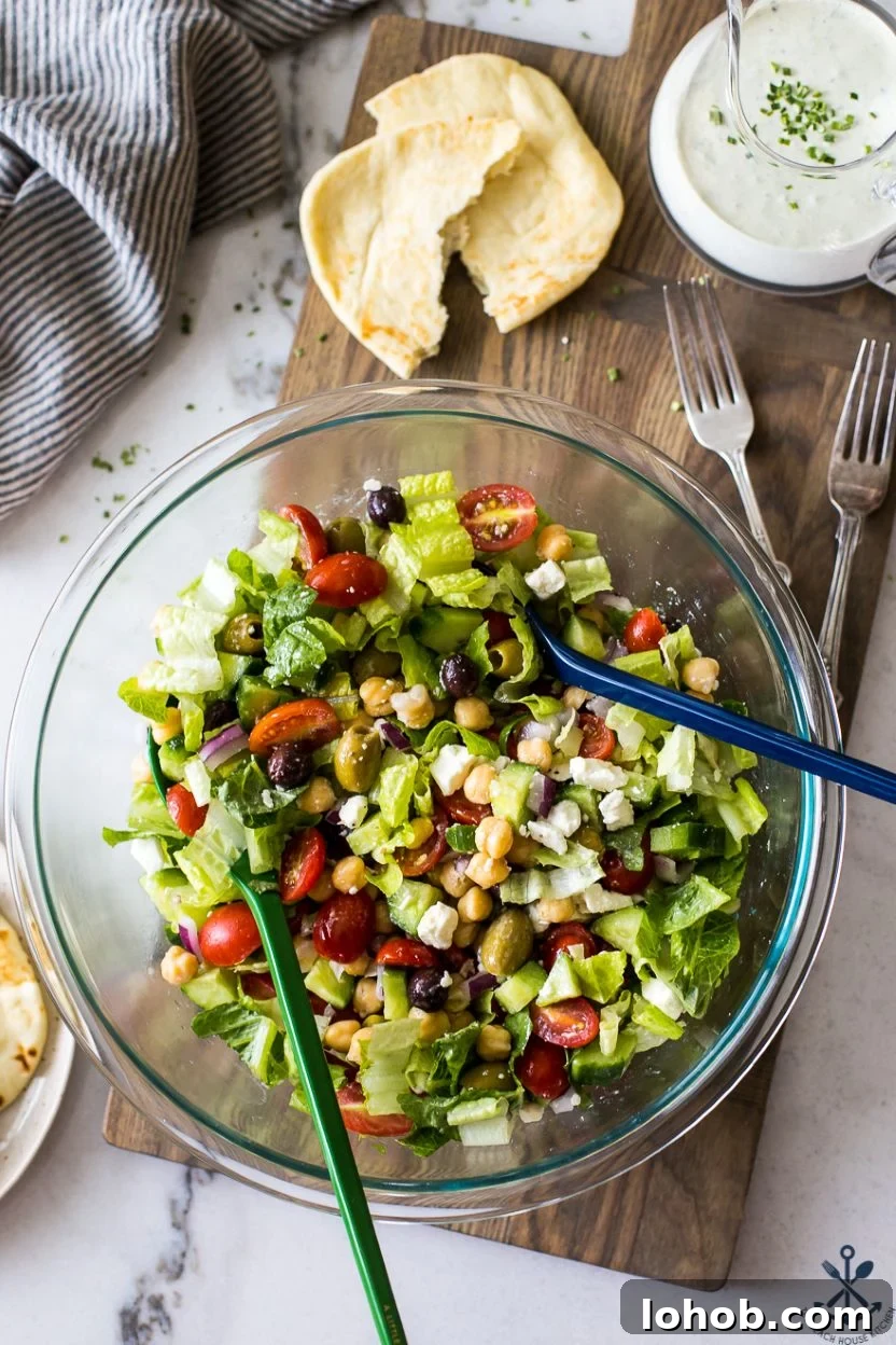 Overhead photo of a glass bowl filled with a Greek salad