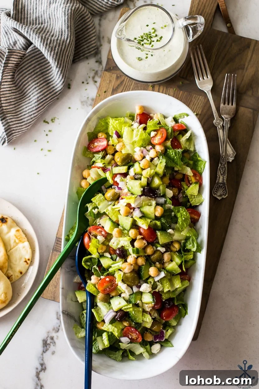 Greek Chickpea Salad with Creamy Green Goddess Dressing 3 Overhead photo of a long serving bowl filled with a Greek salad