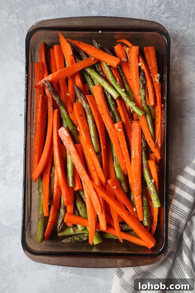 glass baking dish with carrots and asparagus