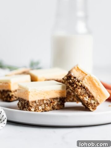 Sliced bars on a white plate with carrots and a jug of milk in the background