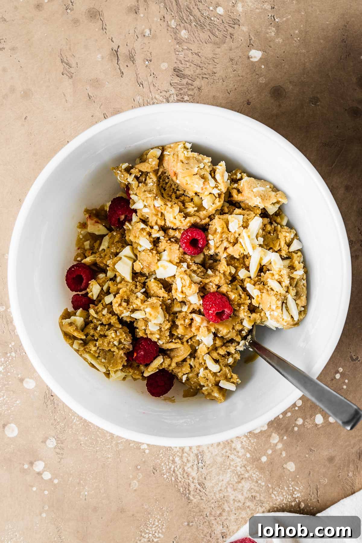 Raspberry White Chocolate Blondies Recipe — Chewy, Fruity Bars 7 Raspberry and white chocolate blondie dough in a mixing bowl.