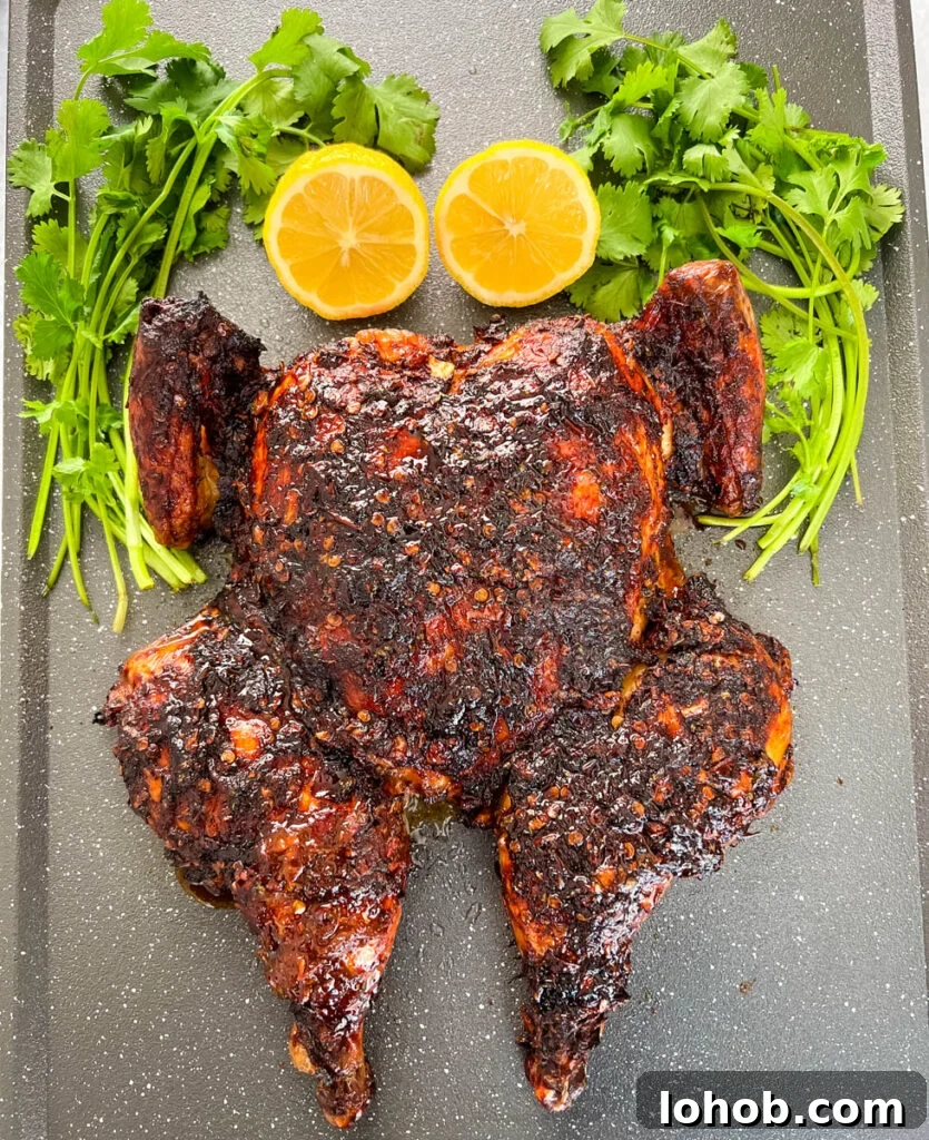 smoked whole chicken on a pan