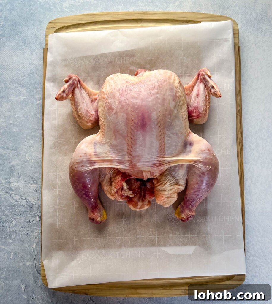raw whole chicken on a cutting board