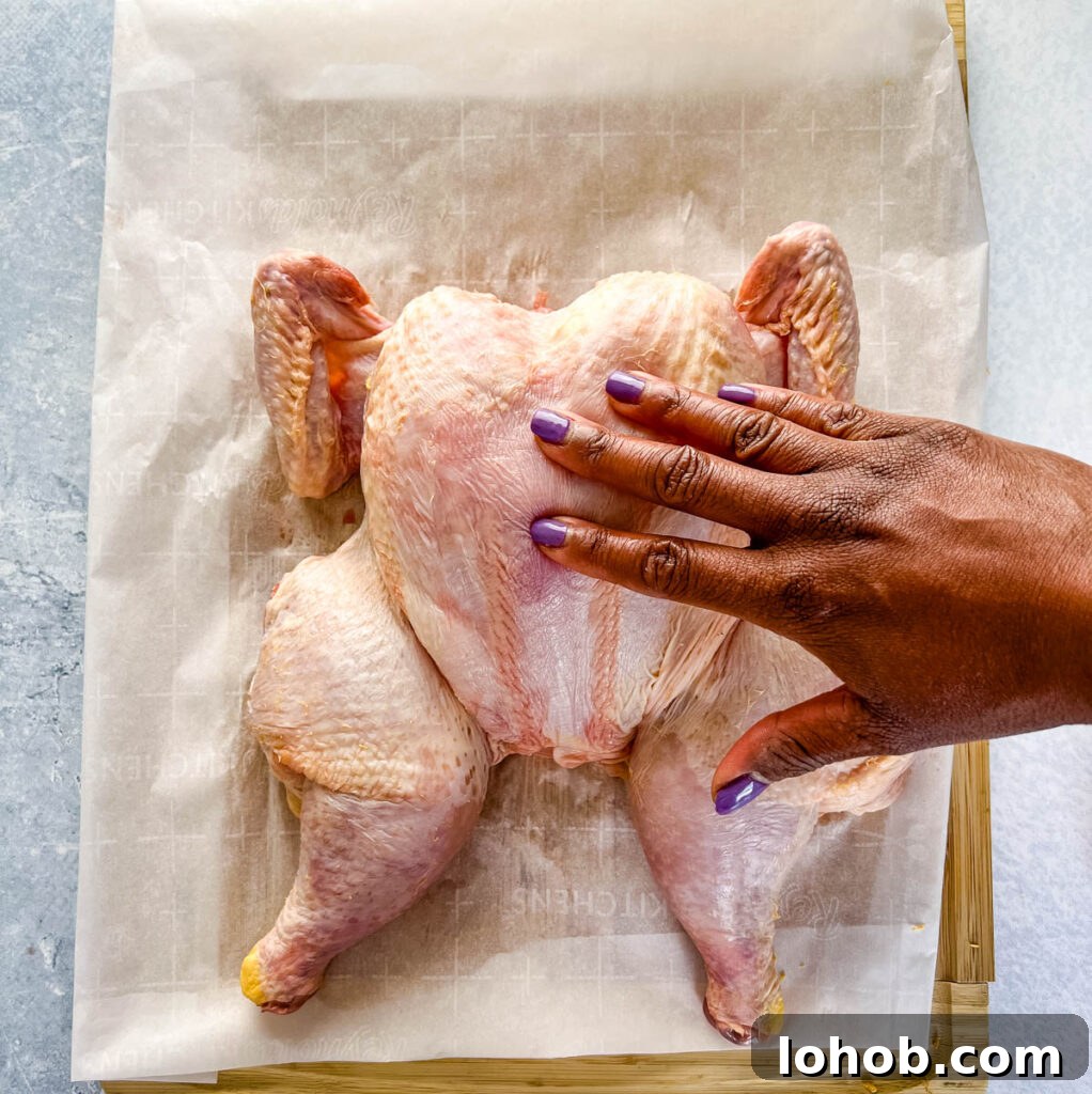 raw whole chicken on a cutting board