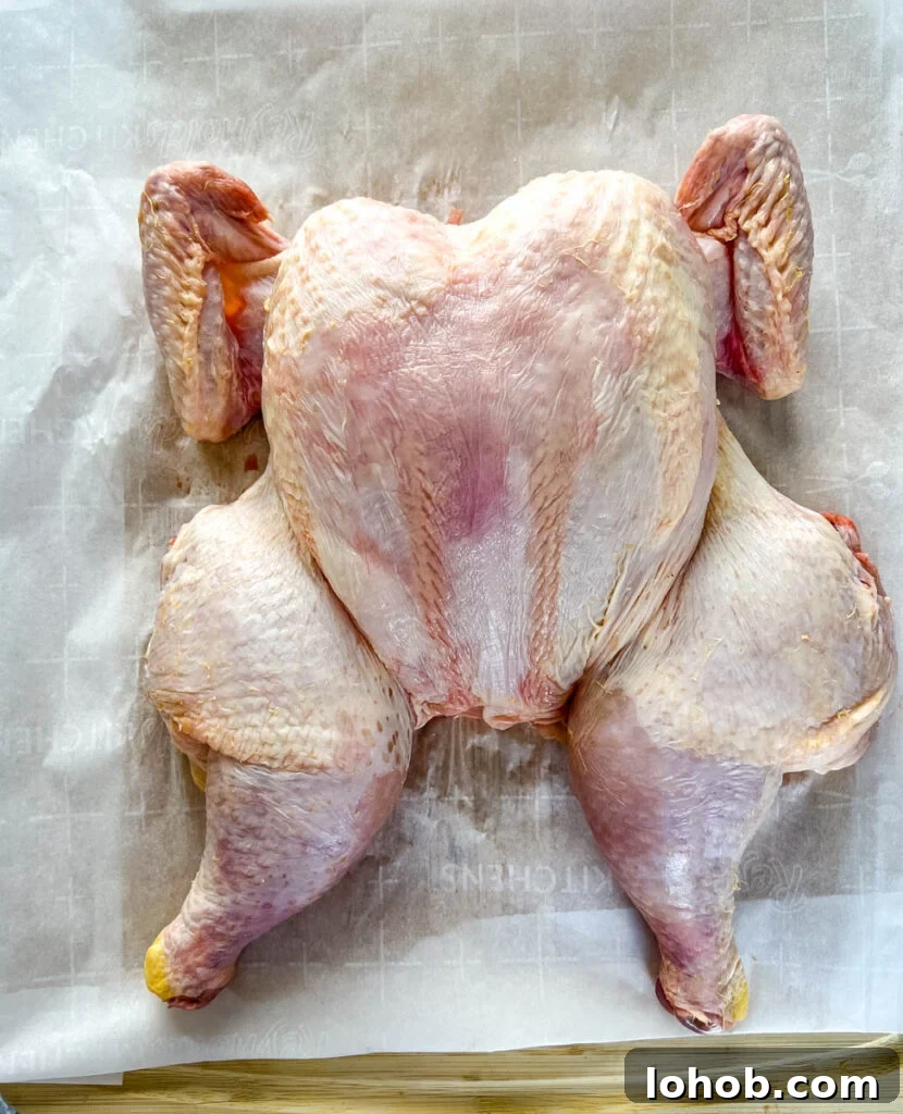raw whole chicken on a cutting board