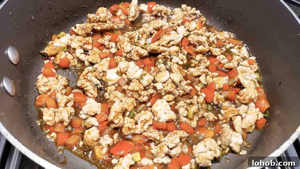easy Asian Chicken Lettuce Wrap filling cooking in a pan.