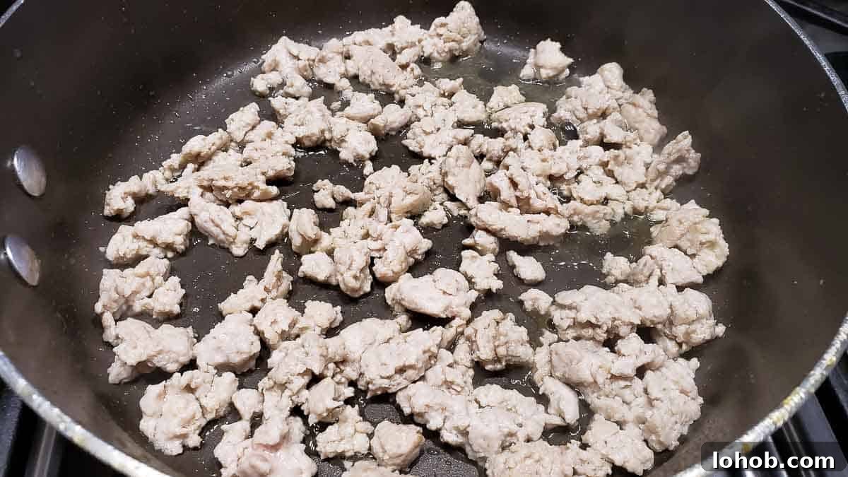 ground chicken cooking in a pan.