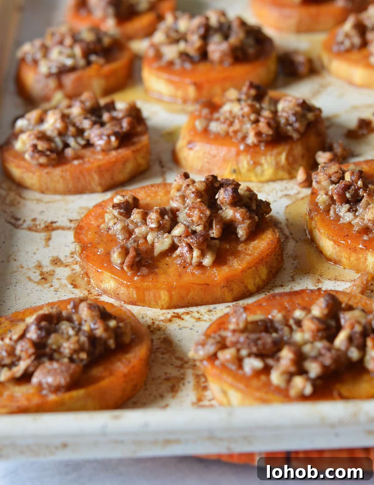 Roasted Sweet Potato Slices with Maple Candied Pecans 2 roasted sweet potato slices with candied pecans.