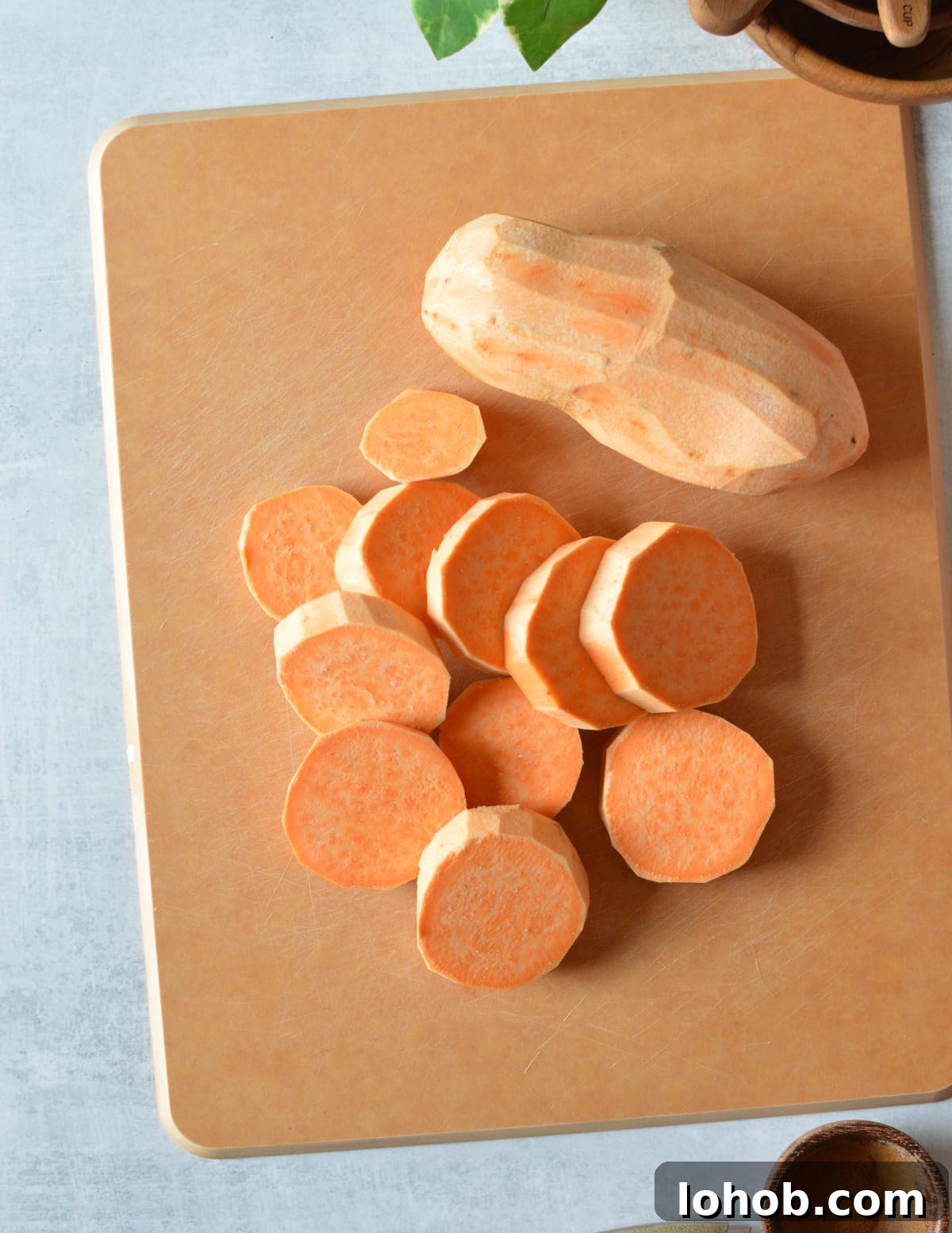 Roasted Sweet Potato Slices with Maple Candied Pecans 5 sliced sweet potatoes on a cutting board.
