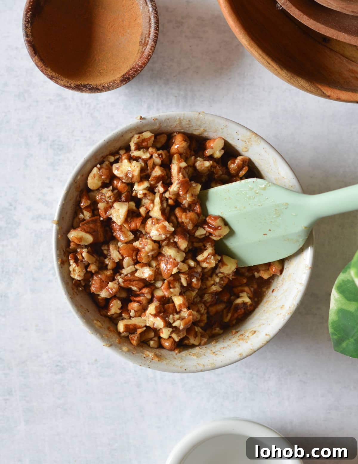 Roasted Sweet Potato Slices with Maple Candied Pecans 8 a bowl of chopped pecans coated in maple syrup and butter.