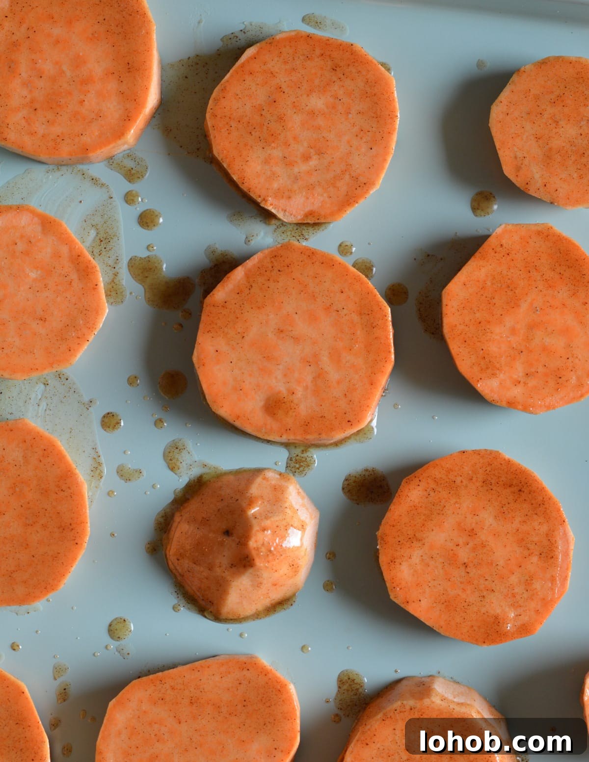 Roasted Sweet Potato Slices with Maple Candied Pecans 9 sliced sweet potatoes coated in maple syrup and butter.