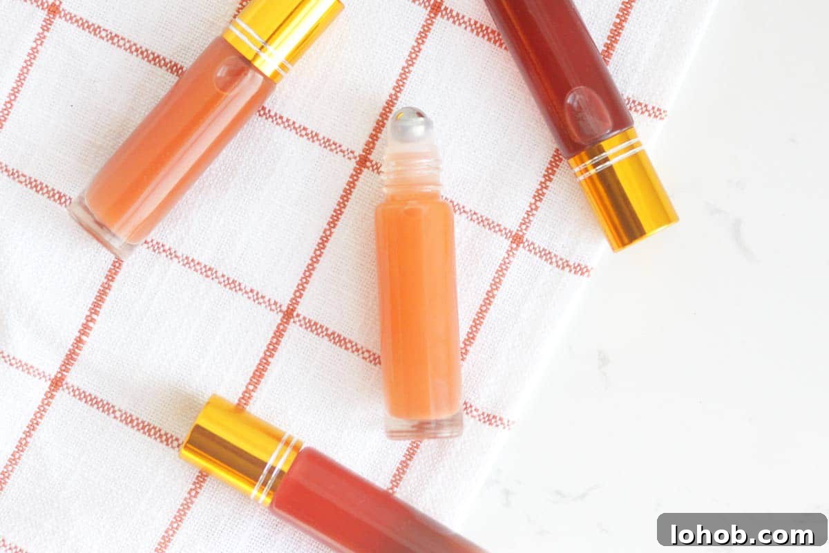 DIY Lip Gloss Without Wax: Step-by-Step Recipe for Glossy Shine 3 a pink lip gloss in a roller ball bottle with several bottles in the background
