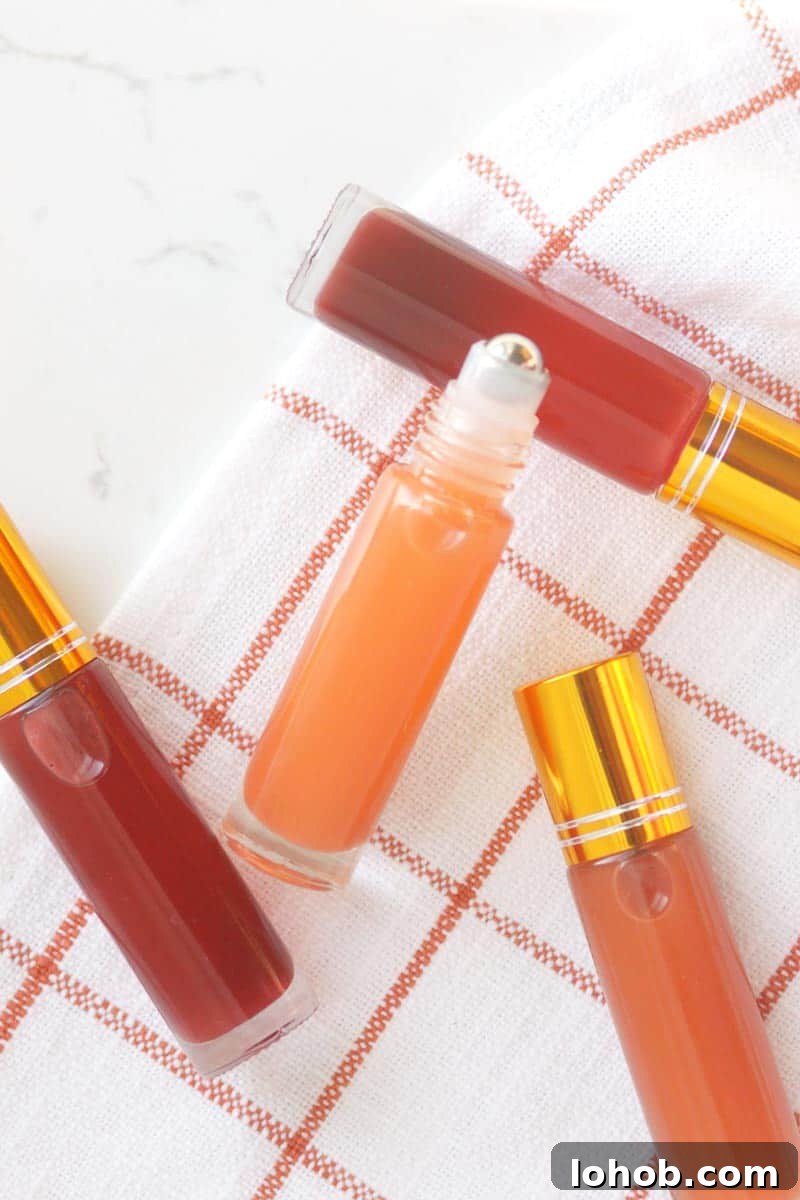 DIY Lip Gloss Without Wax: Step-by-Step Recipe for Glossy Shine 5 a pink lip gloss in a roller ball bottle with several bottles in the background