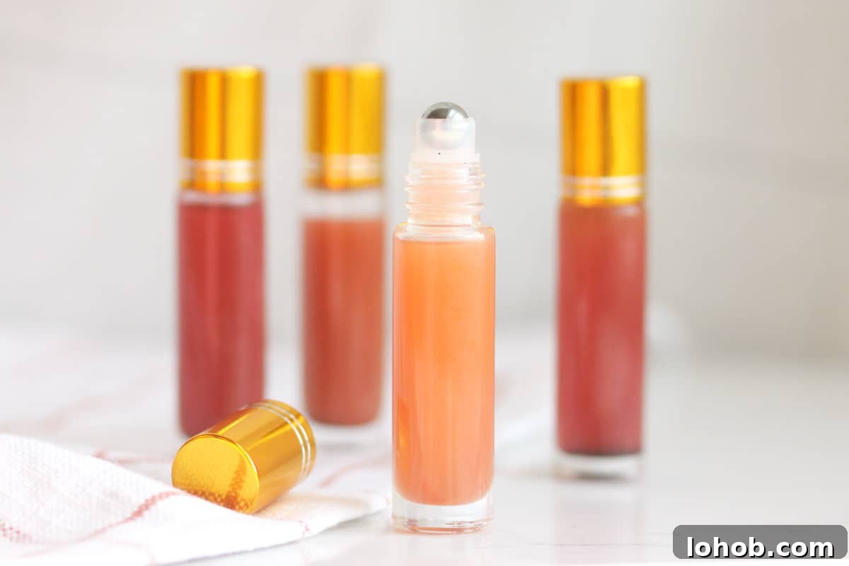 DIY Lip Gloss Without Wax: Step-by-Step Recipe for Glossy Shine 6 a pink lip gloss in a roller ball bottle with several bottles in the background
