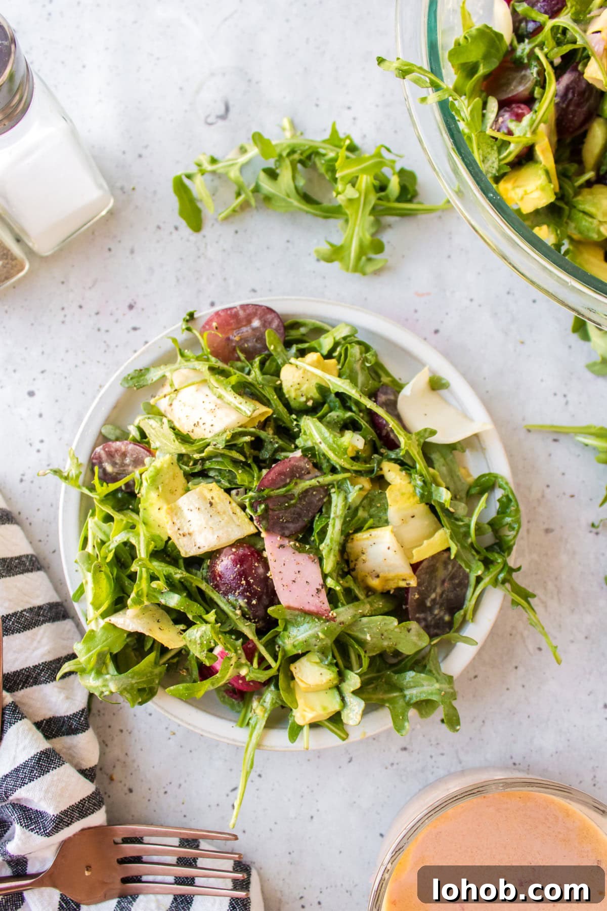 overhead shot of serving of grape avocado and arugula salad