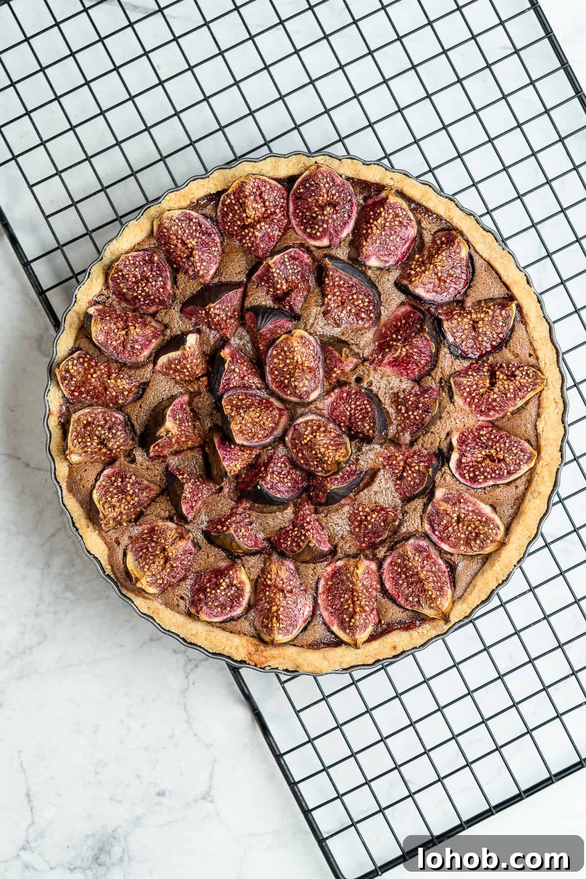 Baked fig tart in a tart tin.