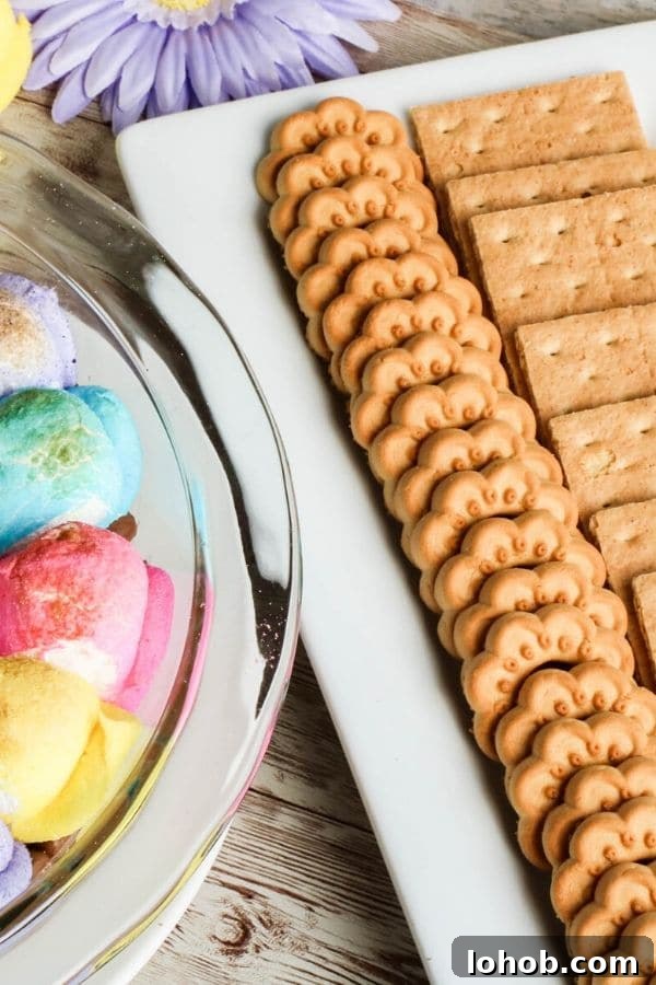 Peep S’mores Dip for Easter: Gooey Marshmallow Dessert Dip 4 cookies on a plate next to a warm s'mores dip