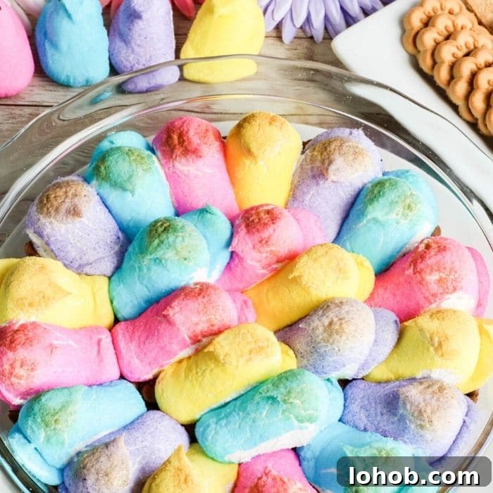 Peep S’mores Dip for Easter: Gooey Marshmallow Dessert Dip 7 peeps in a pie pan that have been cooked in oven